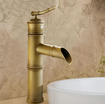 Antique brass vintage bathroom faucet with bamboo-style design and curved spout for bathroom sink use
