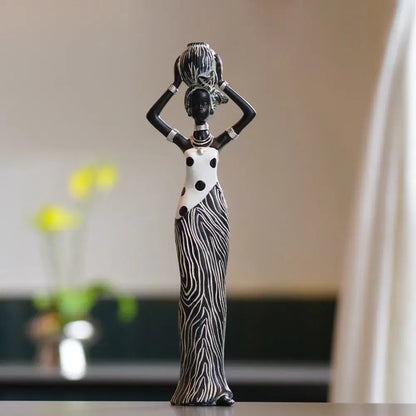 Black and white african women resin figurine in polka dot dress holding decorative vessel for decorbites african women decor