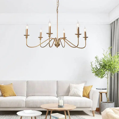 Antique brass metal pendant light with six candle-style bulbs and elegant curved design for dining room chandelier