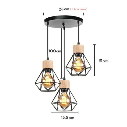 Set of three black iron cage pendant lights with wooden caps and warm filament bulbs for dining room lighting