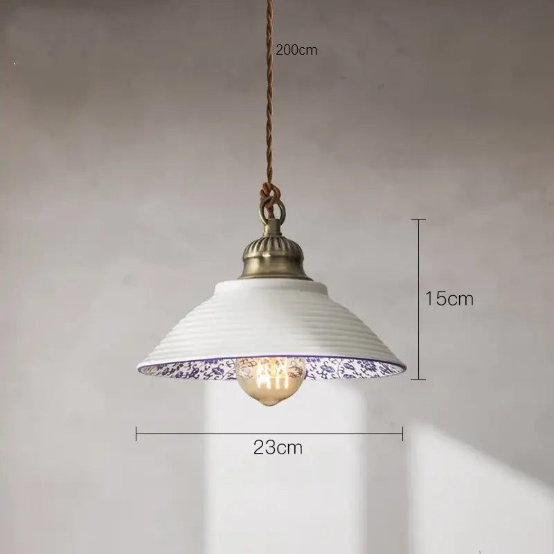 A white ceramic pendant light with blue floral pattern and antique brass fixture decorbites ceramic vintage hanging decor