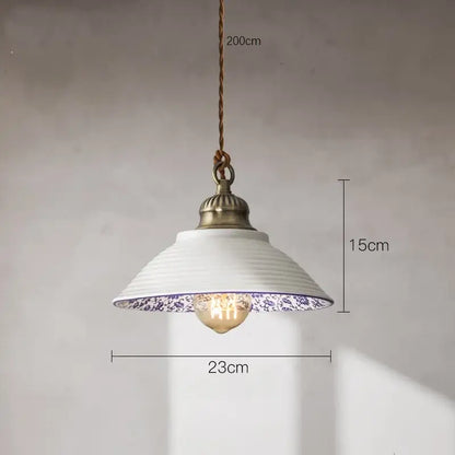 A white ceramic pendant light with blue floral pattern and antique brass fixture decorbites ceramic vintage hanging decor