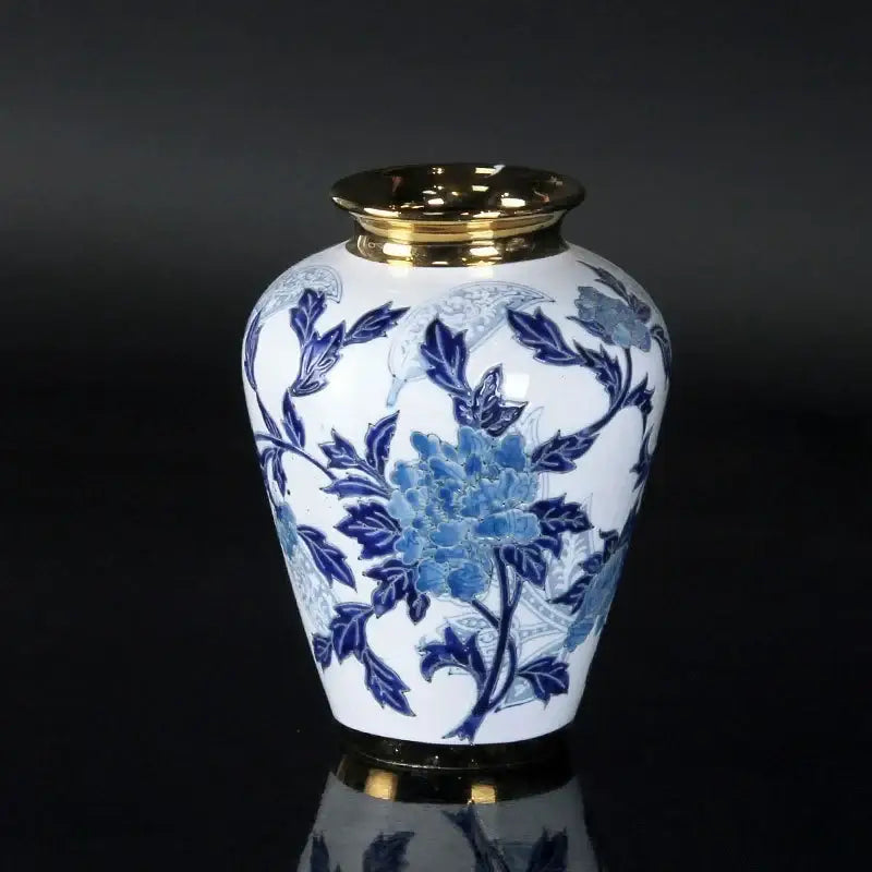 White porcelain ceramic vase with intricate blue floral patterns and gold-trimmed rim for home decor