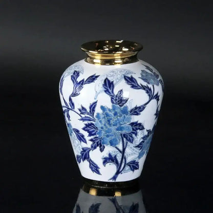 White porcelain ceramic vase with intricate blue floral patterns and gold-trimmed rim for home decor