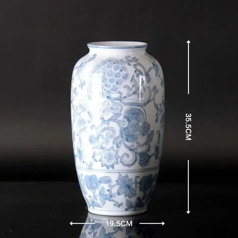 Vintage blue and white porcelain ceramic vase with intricate floral patterns and glossy white porcelain ceramic finish for home decor