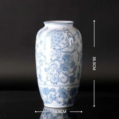 Vintage blue and white porcelain ceramic vase with intricate floral patterns and glossy white porcelain ceramic finish for home decor