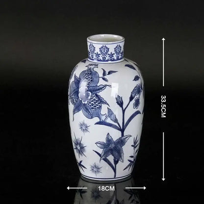 Vintage blue and white porcelain ceramic vase with intricate floral and bird motifs glossy finish for home decor