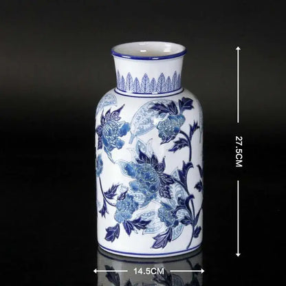 Vintage porcelain ceramic vase in blue and white with intricate floral patterns and a fluted rim for home decor
