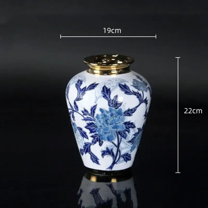 Vintage blue and white porcelain ceramic vase with gold rim and intricate floral patterns for home decor