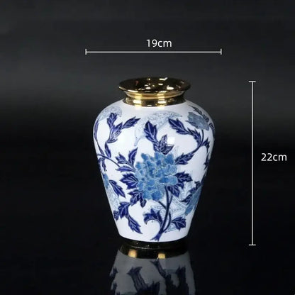 Vintage blue and white porcelain ceramic vase with gold rim and intricate floral patterns for home decor