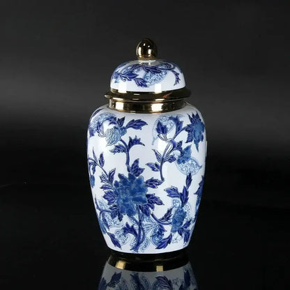 Vintage blue and white porcelain ceramic vase with gold-toned lid and base accents for elegant home decor