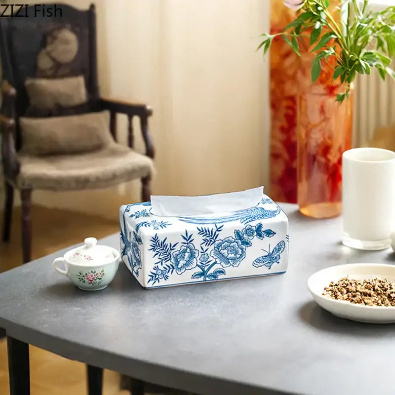 Vintage blue and white porcelain tissue box with floral and butterfly design for living room decor