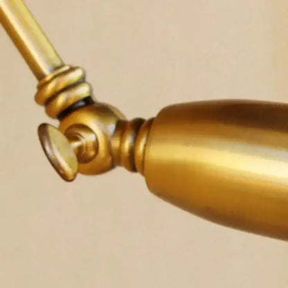 Brass-finished vintage wall light with adjustable long arm and polished cylindrical design for bedroom decorbites decor