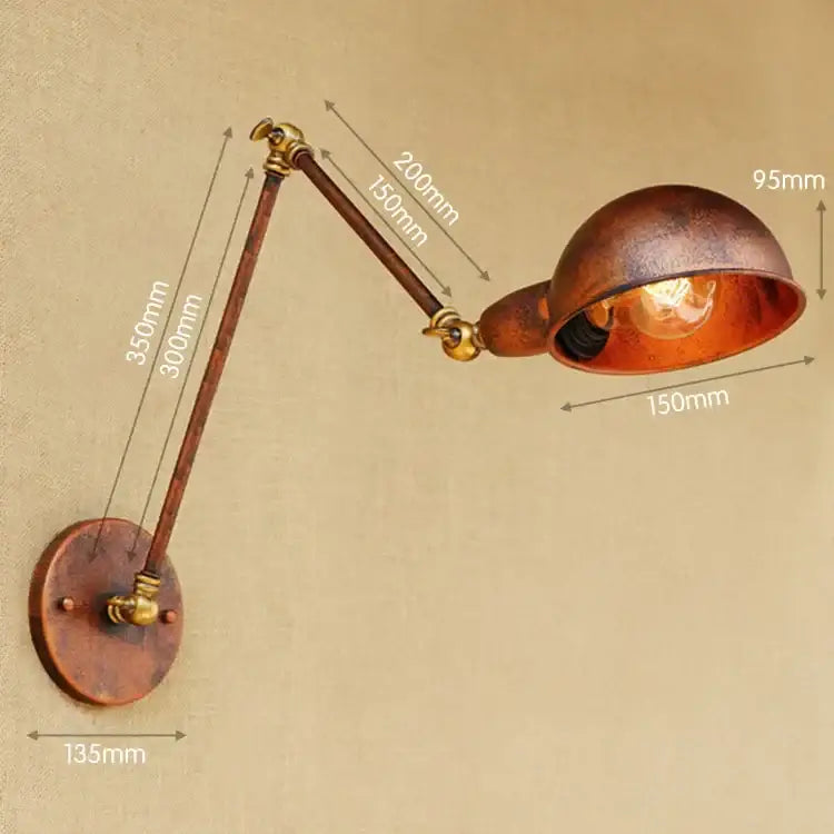 Vintage brass adjustable long arm wall light featuring copper and brass materials with a warm glowing bulb for bedroom decorbites