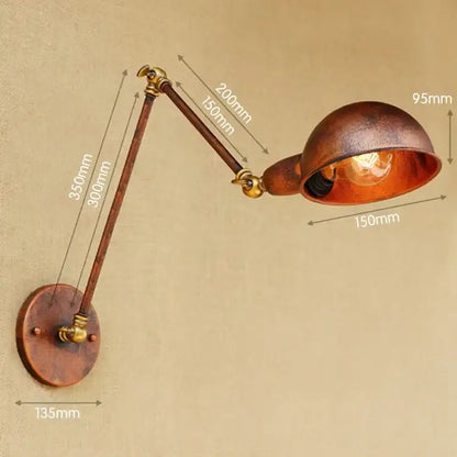 Vintage brass adjustable long arm wall light featuring copper and brass materials with a warm glowing bulb for bedroom decorbites