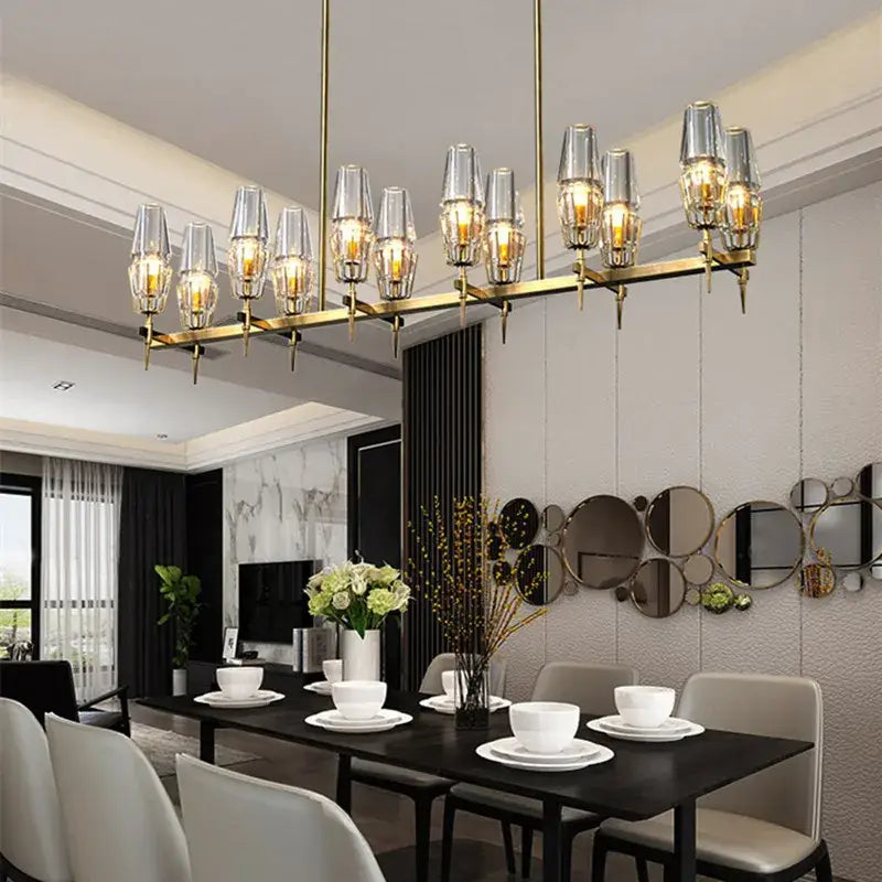Modern decorbites brass ana chandelier featuring gold-toned metal and clear glass shades for dining room lighting
