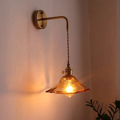 Vintage brass and amber glass copper led wall sconce with warm amber glass pendant and twisted cord for bedroom lighting