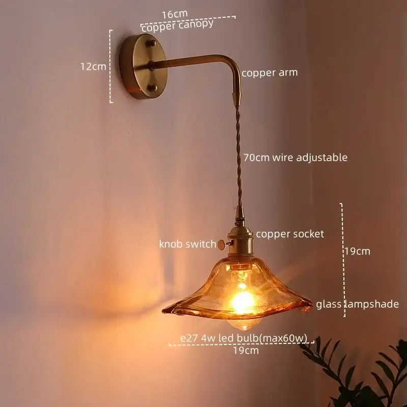 Vintage brass and amber glass copper led wall sconce with warm amber glass and adjustable wire arm for bedroom lighting
