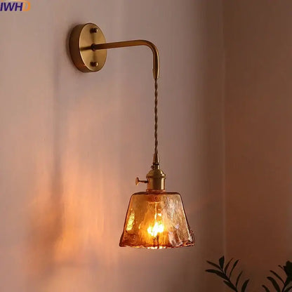 Vintage brass wall sconce with textured amber glass copper led shade and twisted cord for bedroom lighting