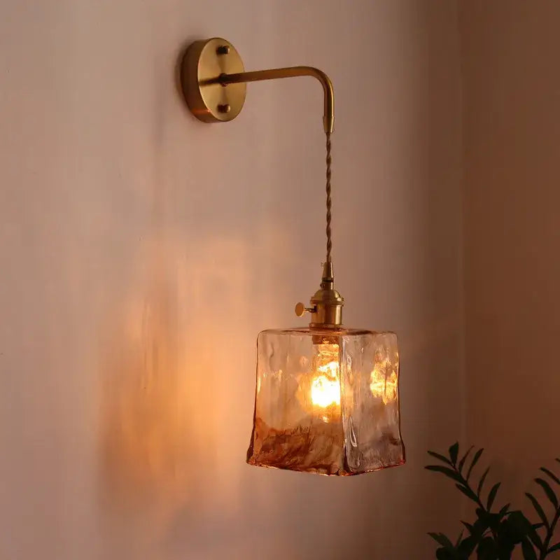 Vintage brass and amber glass copper led wall sconce with warm-toned textured glass and brass-finished metal arm