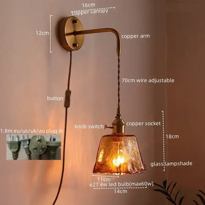 Copper finished vintage brass wall sconce with textured amber glass copper LED shade and adjustable braided wire