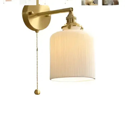 Vintage brass led wall lamp featuring a gold-toned ornate fixture with a ribbed off-white glass shade for bedroom use
