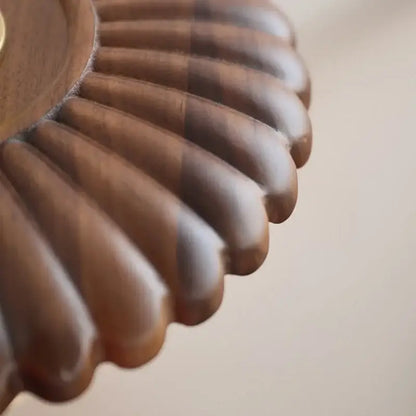A vintage brass and amber glass wall lamp with a warm scalloped walnut wood tray by decorbites led walnut