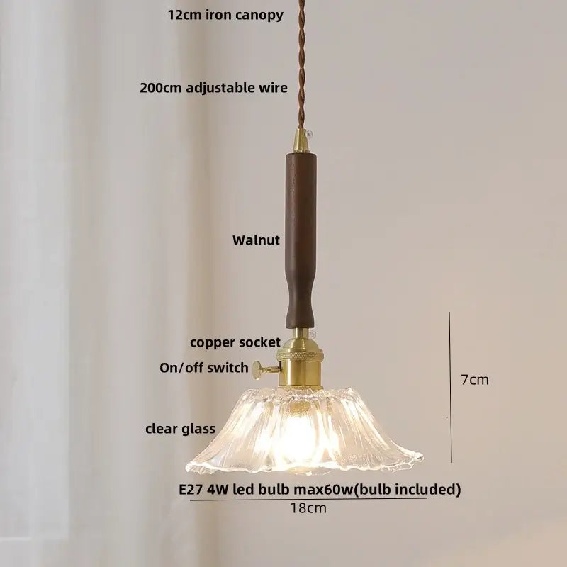 A delicate clear glass pendant light with fluted design and ceramic walnut wood handle from decorbites ceramic walnut