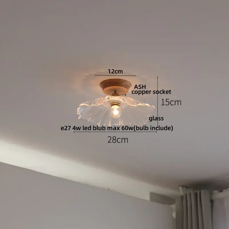 Vintage brass and clear glass led ceiling light with a delicate flower-shaped clear glass led and ash copper socket
