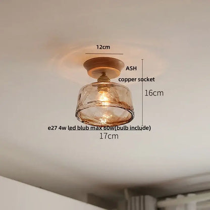 Vintage brass and clear glass led ceiling light featuring warm amber glass pendant with copper socket and wooden base for bedroom decorbites clear glass