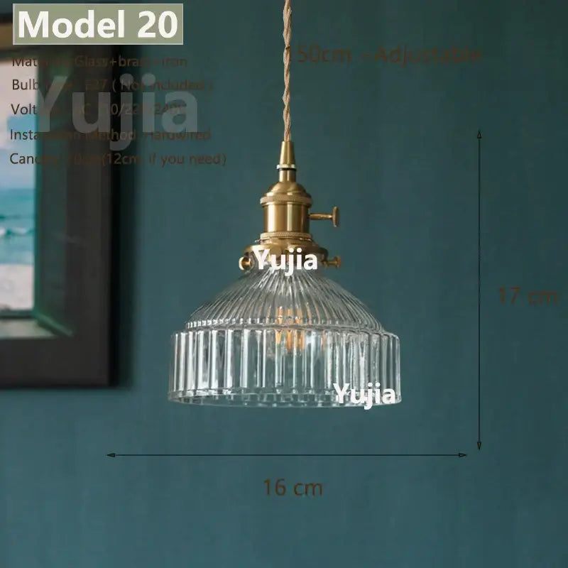Vintage brass and clear glass pendant light with ribbed shade and adjustable cord featuring polished copper fixture