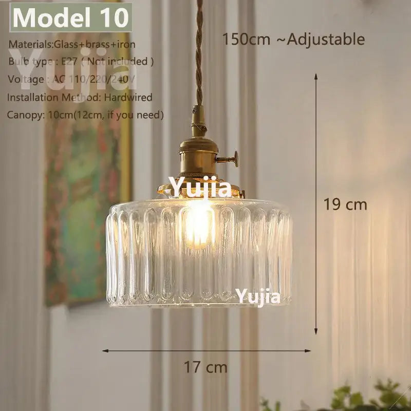 Vintage brass and clear glass pendant light with vertical ridges and iron hardware featuring polished copper accents