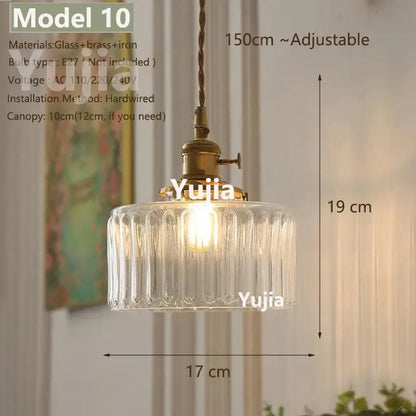 Vintage brass and clear glass pendant light with vertical ridges and iron hardware featuring polished copper accents