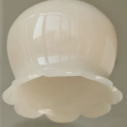A glossy white ceramic bowl with scalloped rim paired with vintage brass and cream resin led wall sconce bedroom light decorbites cream resin