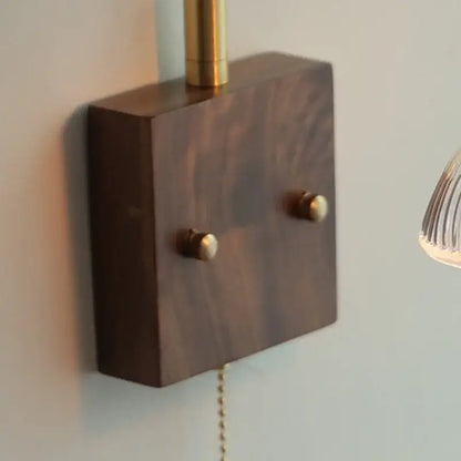 Dark wood wall sconce base with brass accents and two round knobs for vintage glass pink led wall lamp