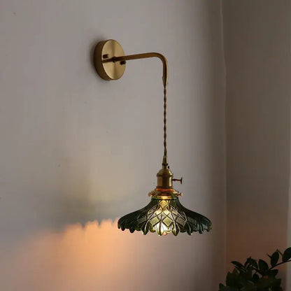 Antique brass led wall lamp with dark green leaf-shaped glass shade featuring intricate cut patterns for living room