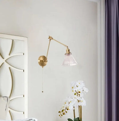 A vintage brass wall lamp with a pink glass led shade and adjustable arm for bedroom use wall lamps green glass led