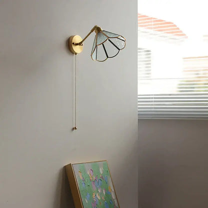 Vintage brass and green glass led wall lights with a gold-toned sconce and petal-like stained glass shade for bedroom use