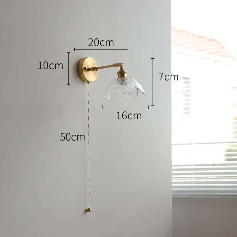 Gold-finished wall sconce with clear textured glass shade and adjustable arm for vintage brass and green glass led wall lights