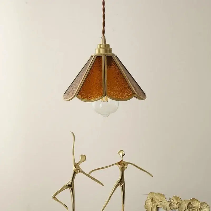 Vintage brass pendant light with warm amber glass and twisted cord suspension for stylish bedroom decorbites decorbites blue glass