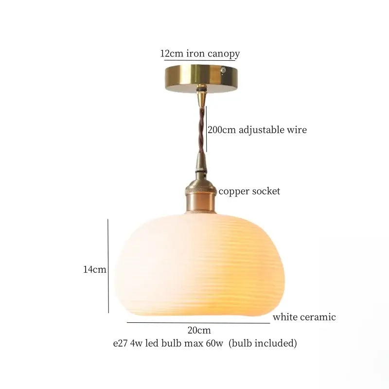 A warm glowing off-white ceramic led pendant light with textured surface and vintage brass fittings for dining room decorbites ceramic led