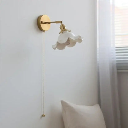 A delicate white ceramic led wall light with ruffled shade and vintage brass hardware for bathroom mirror decorbites ceramic led