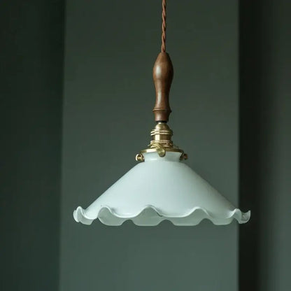 Delicate off-white glass led pendant flower light with scalloped edge and polished vintage brass fixture for bedroom use