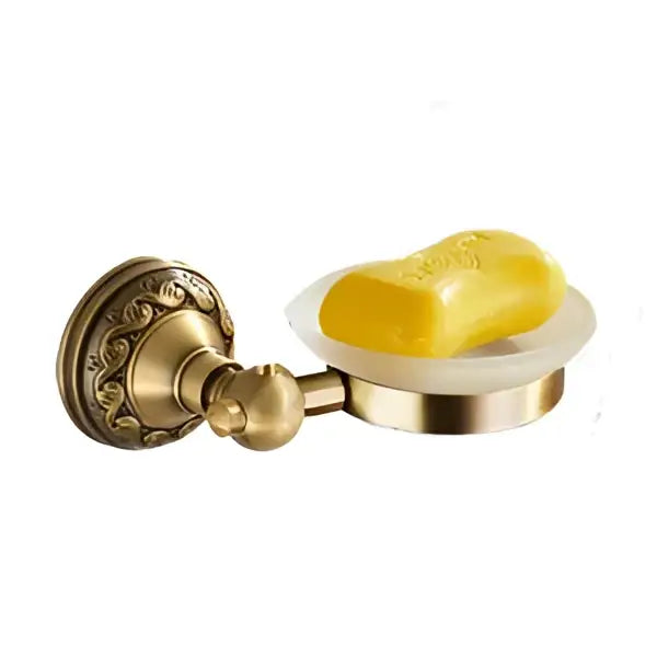 Antique brass wall-mounted soap dish holding a yellow bar of soap from a vintage brass bathroom accessories set