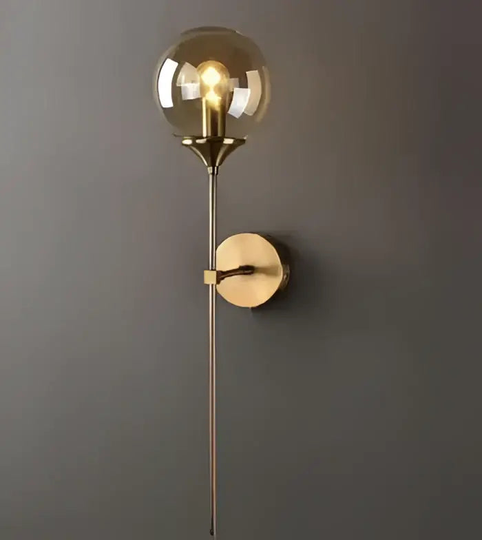 Vintage brass ceramic wall lamp with knob switch featuring a gold-toned glass globe and slender metallic stem for decorbites ceramic wall