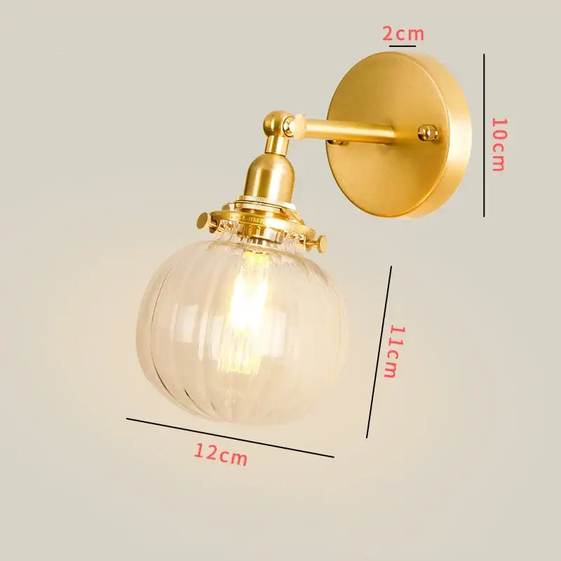 Gold-toned vintage brass chevron clear glass led wall lamp with ribbed globe and brass-finished hardware bedroom sconce