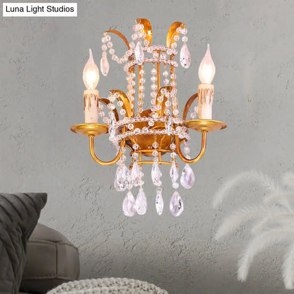 Gold-toned vintage brass wall lamp chandelier sconce with clear crystal teardrop pendants and direct wired bulbs