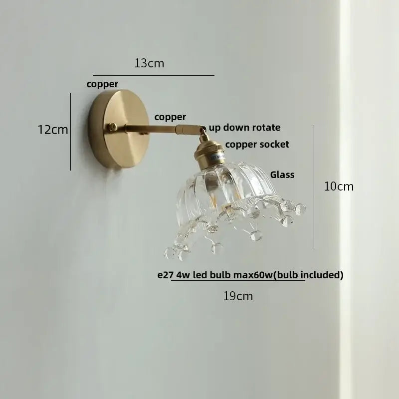 Vintage brass wall lamp with faceted clear glass shade, dangling crystals, and pull chain switch for bathroom use