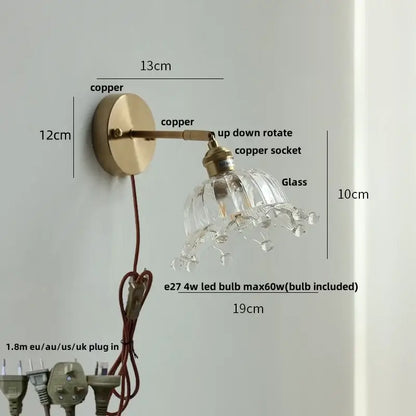 Vintage brass wall lamp with clear glass shade, dangling crystal droplets, and pull chain switch for bathroom use