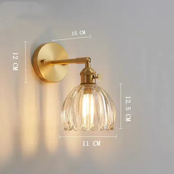 Antique brass-finished wall light with a ribbed clear glass shade for vintage bedroom decorbites clear glass style